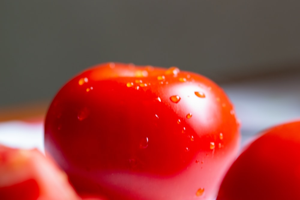 red tomato in close up photography