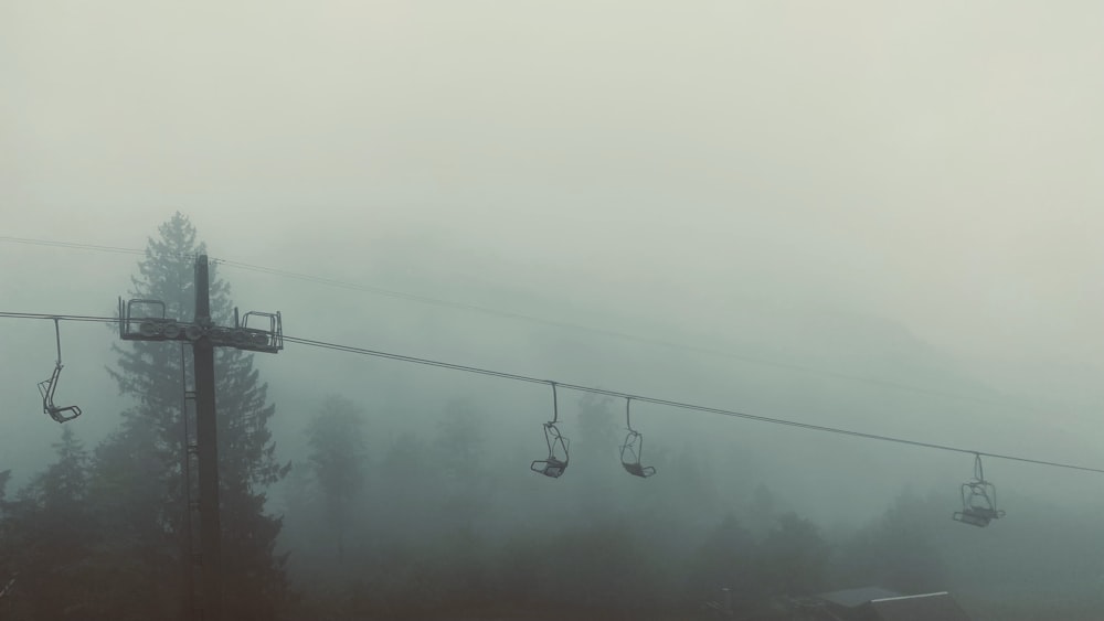 black cable cars under gray sky