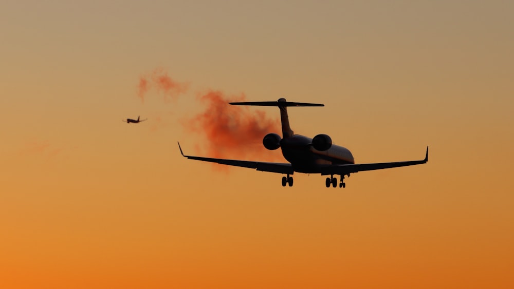 white and black airplane flying in the sky during daytime