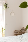 brown wicker armchair beside white wall