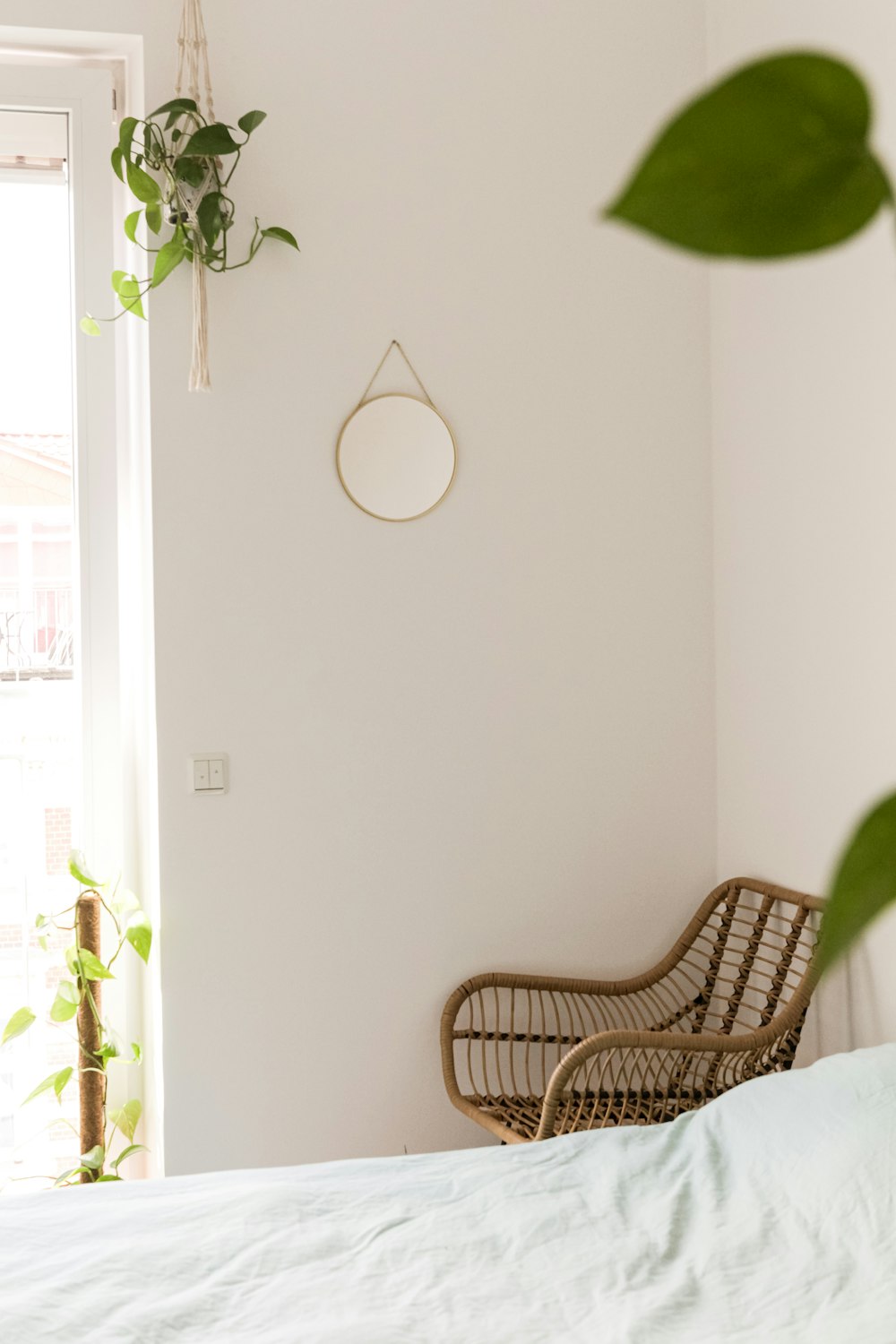 brown wicker armchair beside white wall