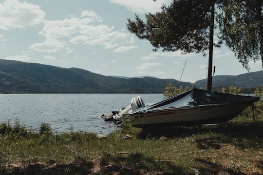 white and black boat on body of water during daytime in Dalen Norway