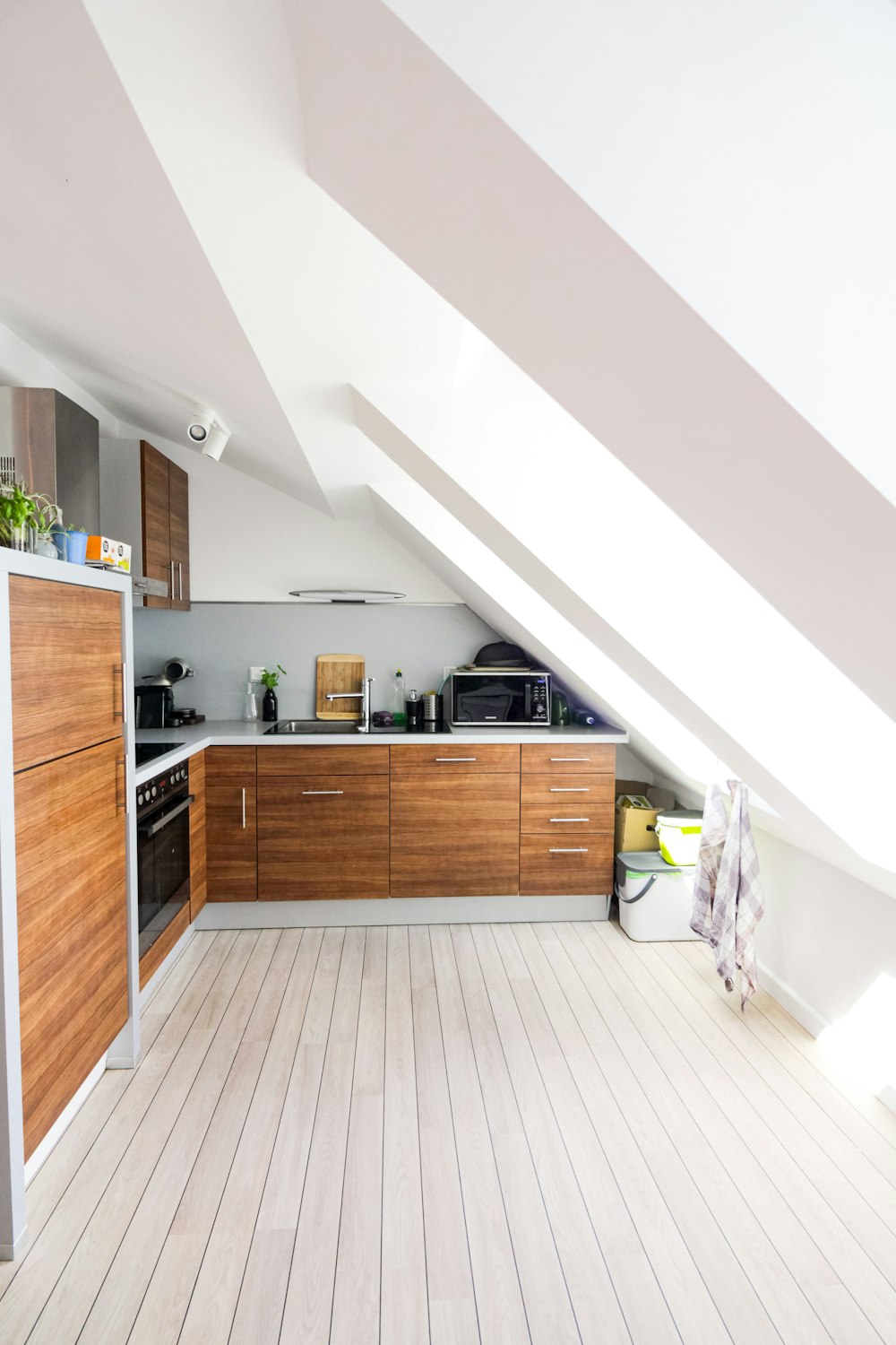 brown wooden kitchen cabinet near white wall