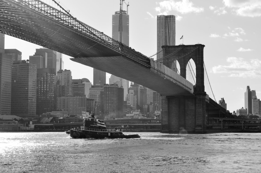 grayscale photo of bridge over body of water