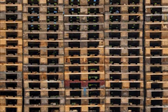 a large stack of wooden pallets stacked on top of each other