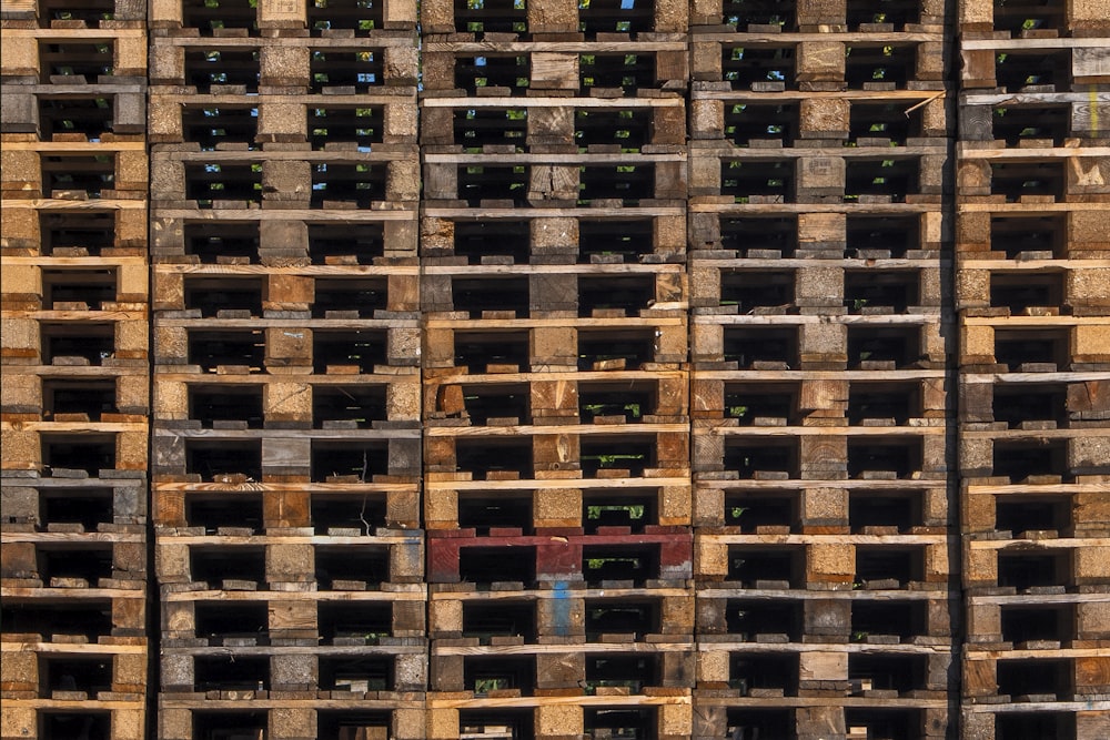 a large stack of wooden pallets stacked on top of each other