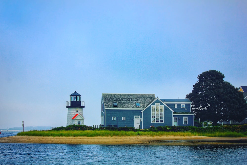 white and black house near body of water during daytime