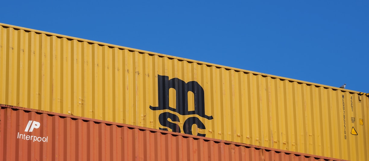 a blue sky with a yellow and orange container on top of it