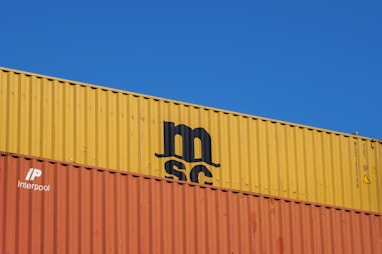 a blue sky with a yellow and orange container on top of it