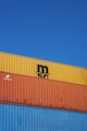 a blue sky with a yellow and orange container on top of it