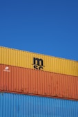 a blue sky with a yellow and orange container on top of it