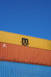 a blue sky with a yellow and orange container on top of it