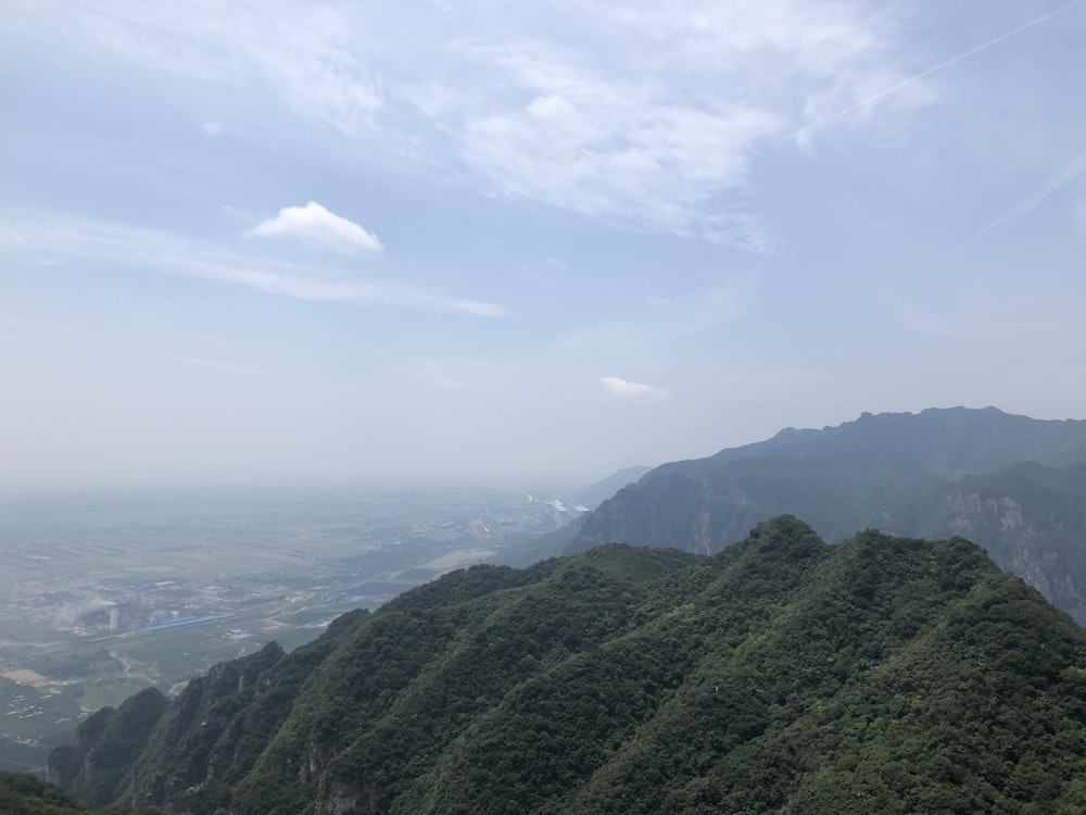 green mountains under white clouds during daytime