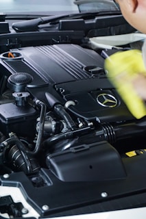 black car engine bay and yellow plastic cup