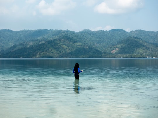 person in black wet suit on body of water during daytime in Pulau Balak Malaysia