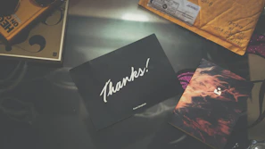 Smiling customer holding a thank you card