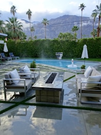 A serene backyard oasis with modern landscaping and seating areas.