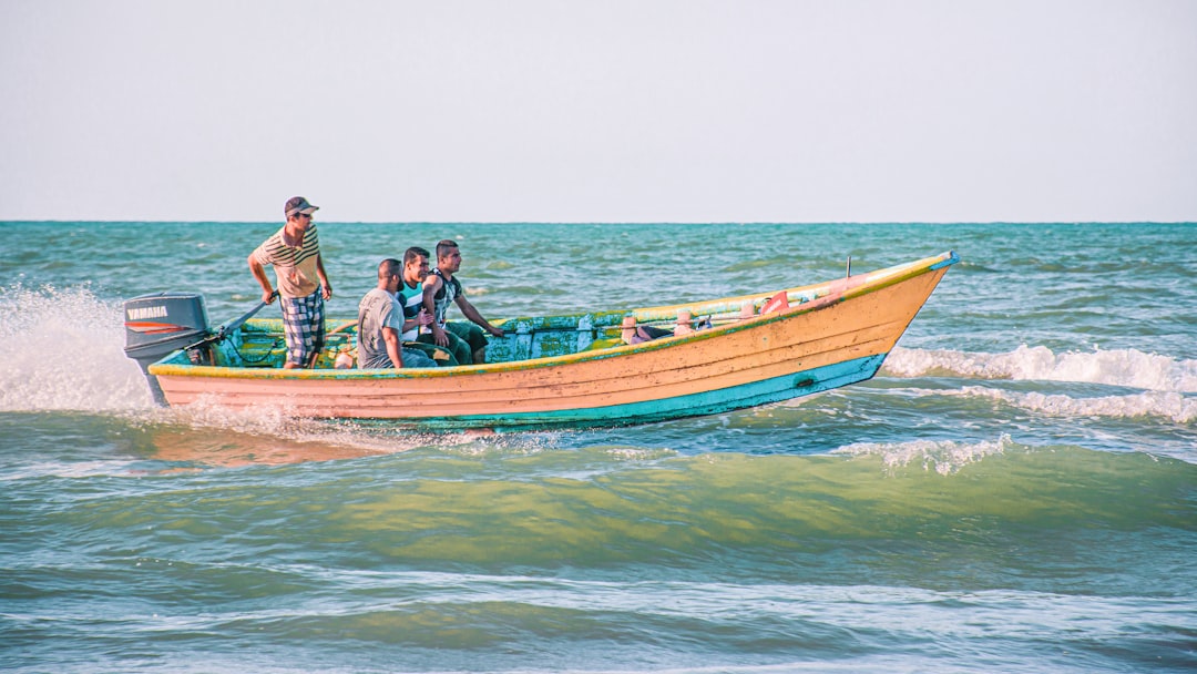 people riding on brown and white boat on sea during daytime