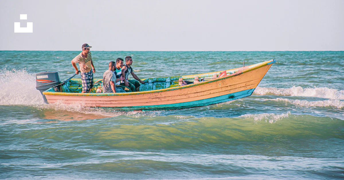 People riding on brown and white boat on sea during daytime photo ...