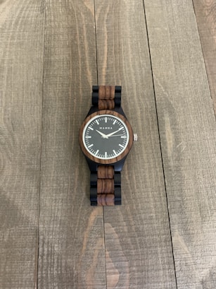 brown and white analog watch at 10 10