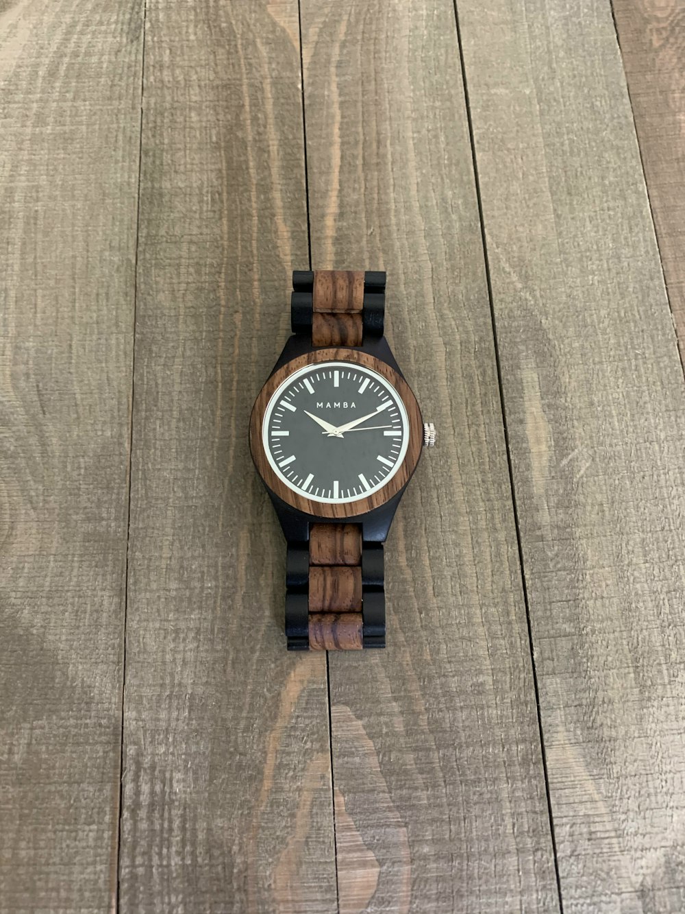 brown and white analog watch at 10 10