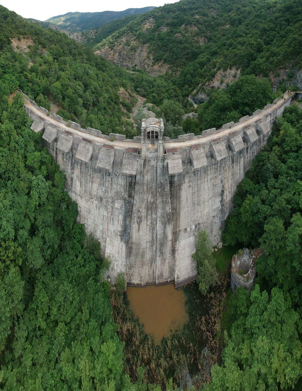 aerial view of waterfalls in the middle of green trees