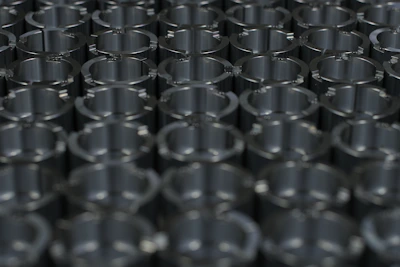 Rows of neatly organized metal parts freshly machined, highlighting uniformity and quality control.