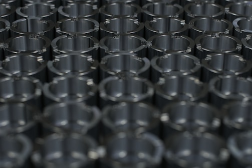A close-up of various neodymium magnets arranged neatly on a surface.
