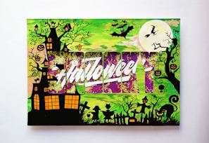A Halloween-themed illustration featuring a haunted house surrounded by twisted trees with jack-o'-lanterns and spiders hanging from the branches. There's a large full moon with a witch flying on a broomstick, and several bats fill the sky. Silhouettes of gravestones, a cat with glowing eyes, and children in costumes are at the bottom. The word 'Halloween' is prominently displayed across the center with a stylized, vibrant design in purple and white.
