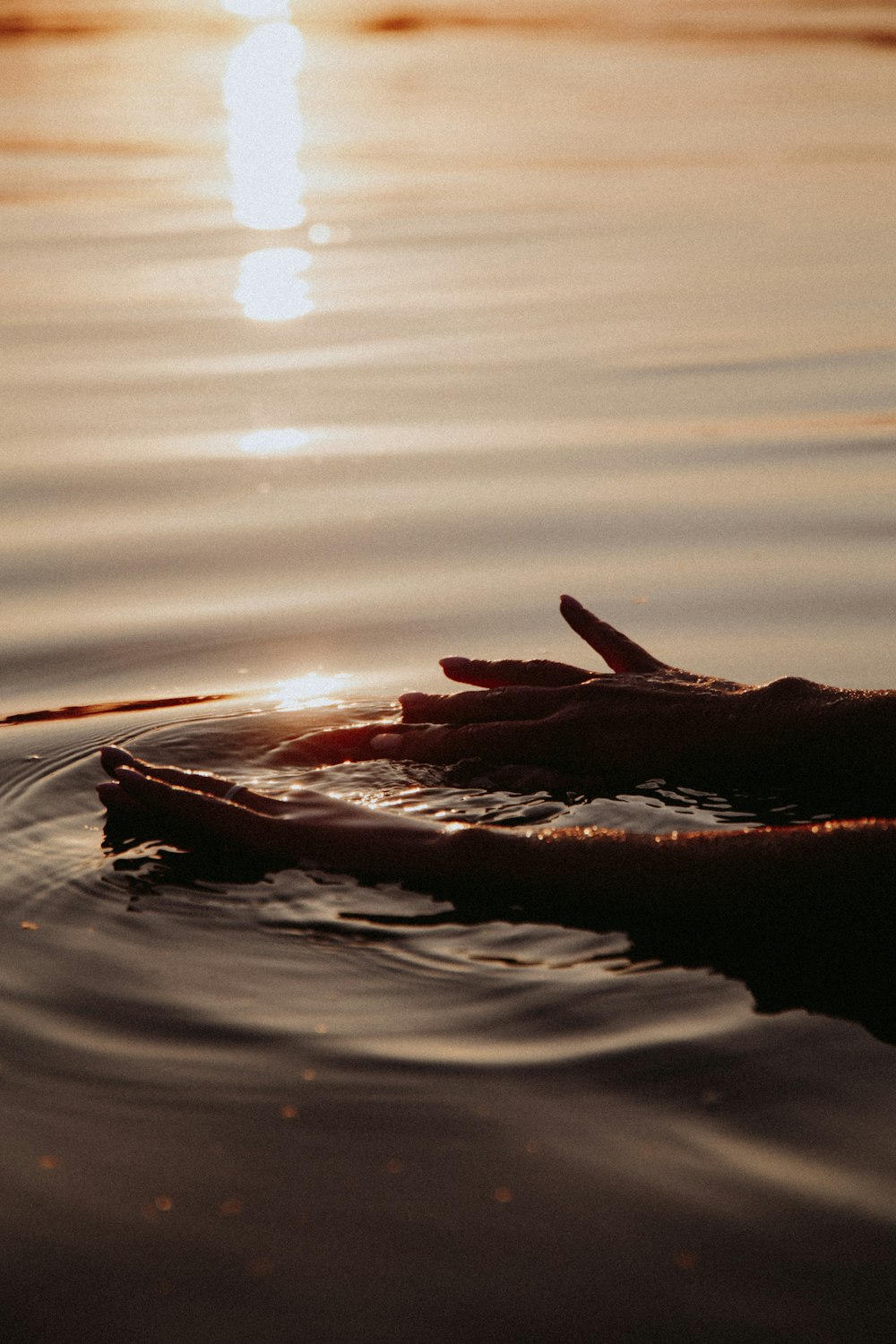 brown rock in the middle of water