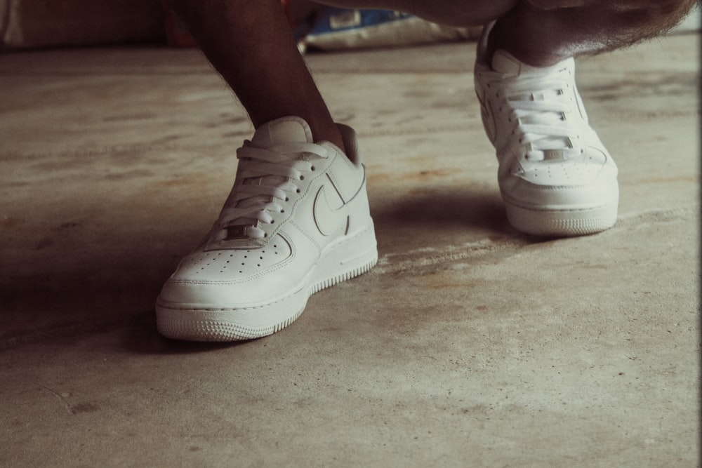 person wearing white nike air force 1 low