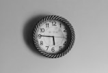 black and white analog wall clock at 10 10