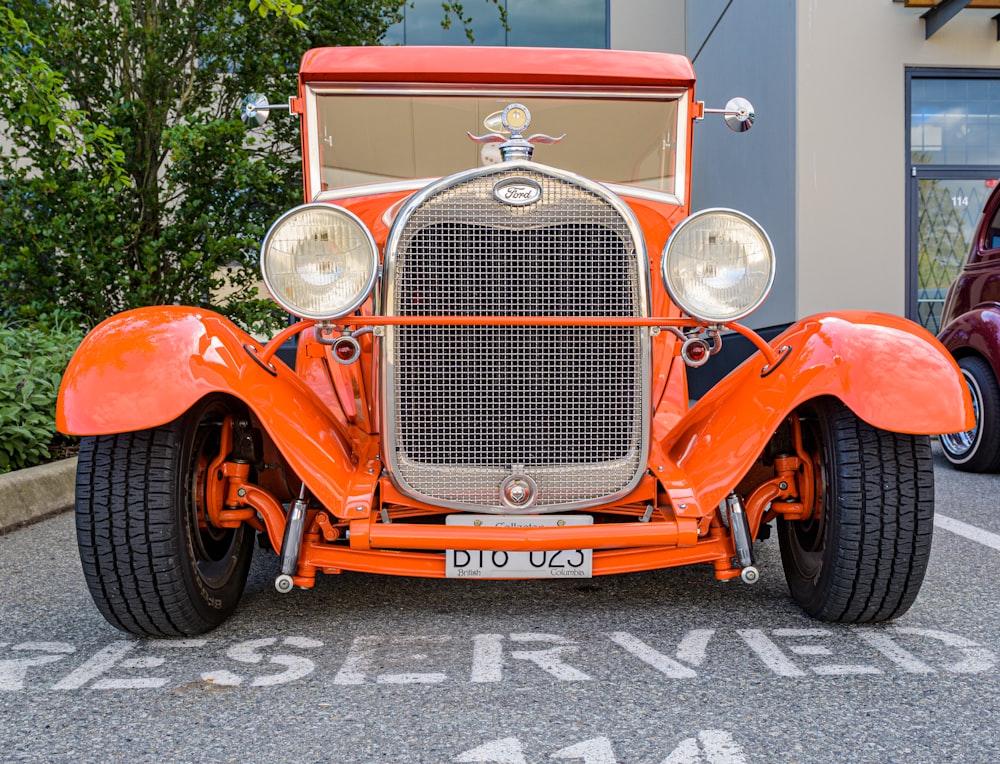 red vintage car on road during daytime