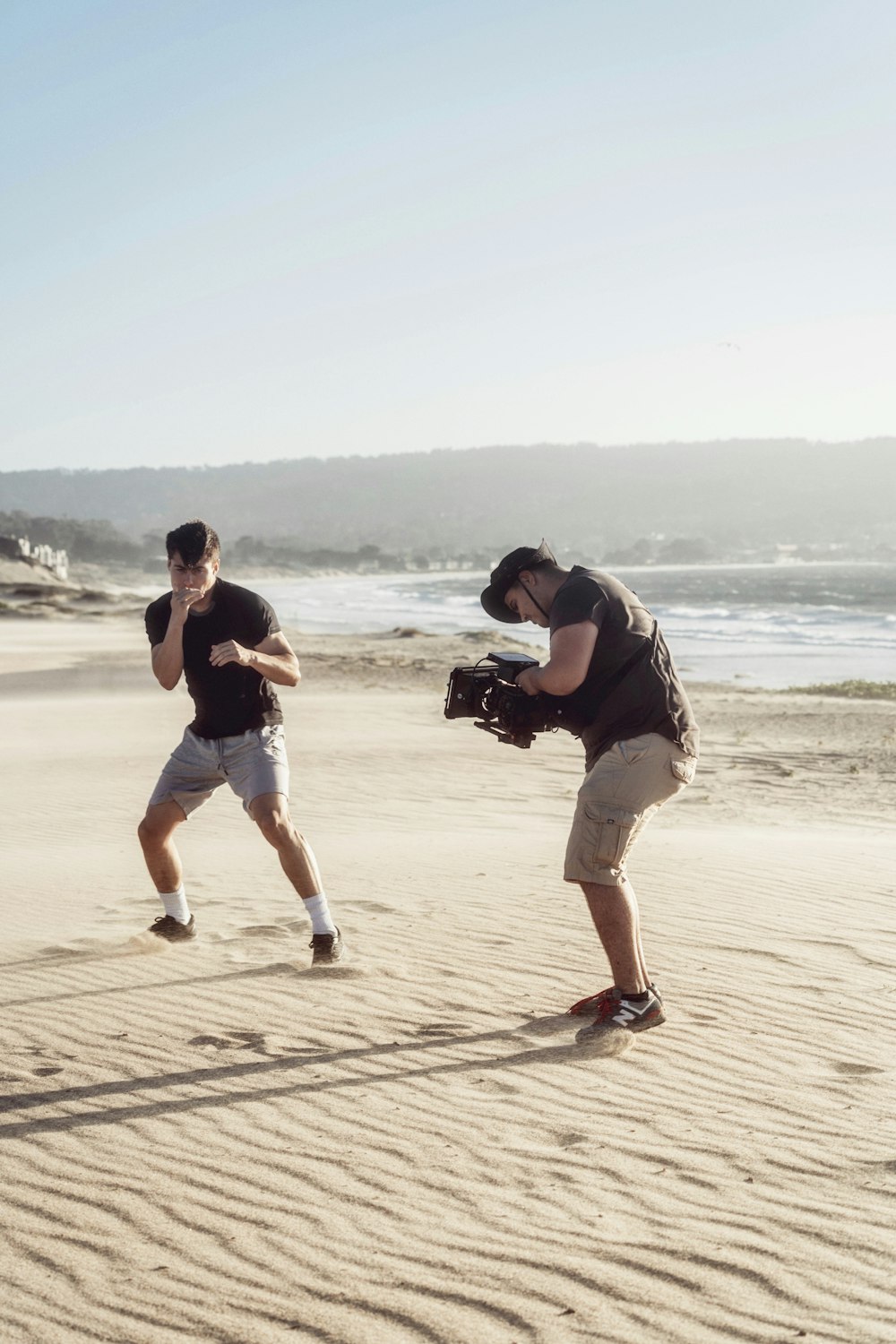 man and woman kissing on beach during daytime