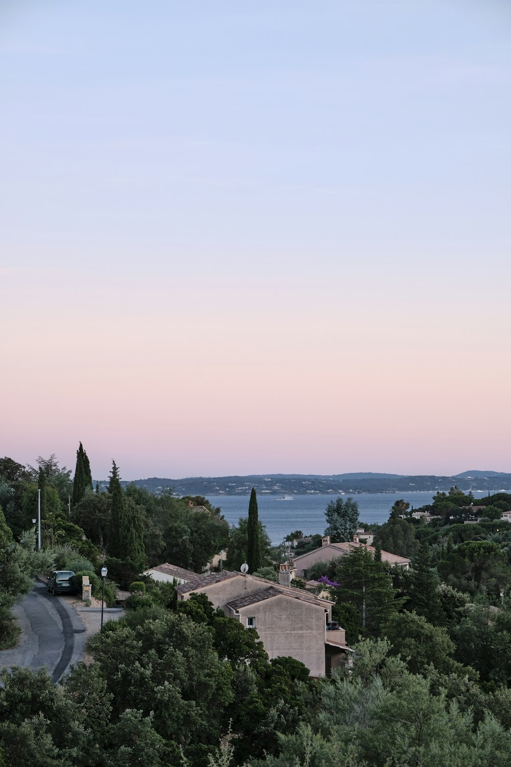 green trees and houses under blue sky during daytime