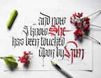 A vibrant calligraphy pen with a curved nib poised over a sheet of elegant handwriting.