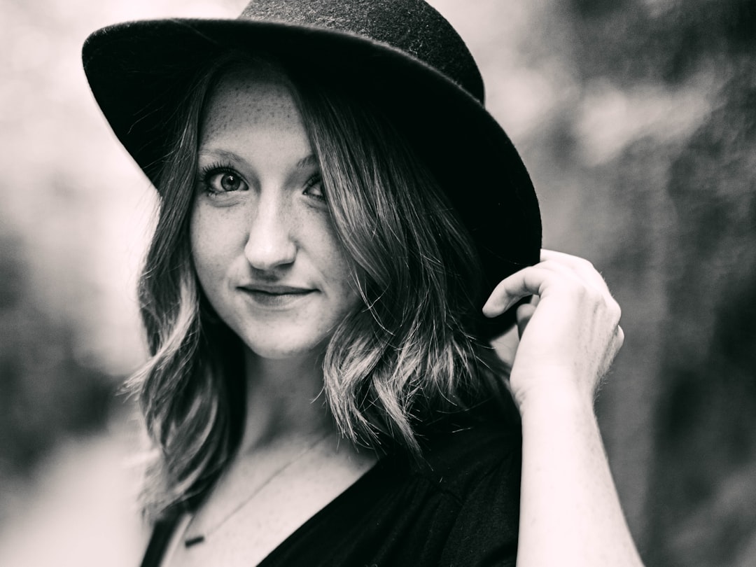 woman in black hat smiling