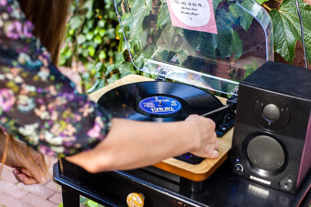 person holding black vinyl record