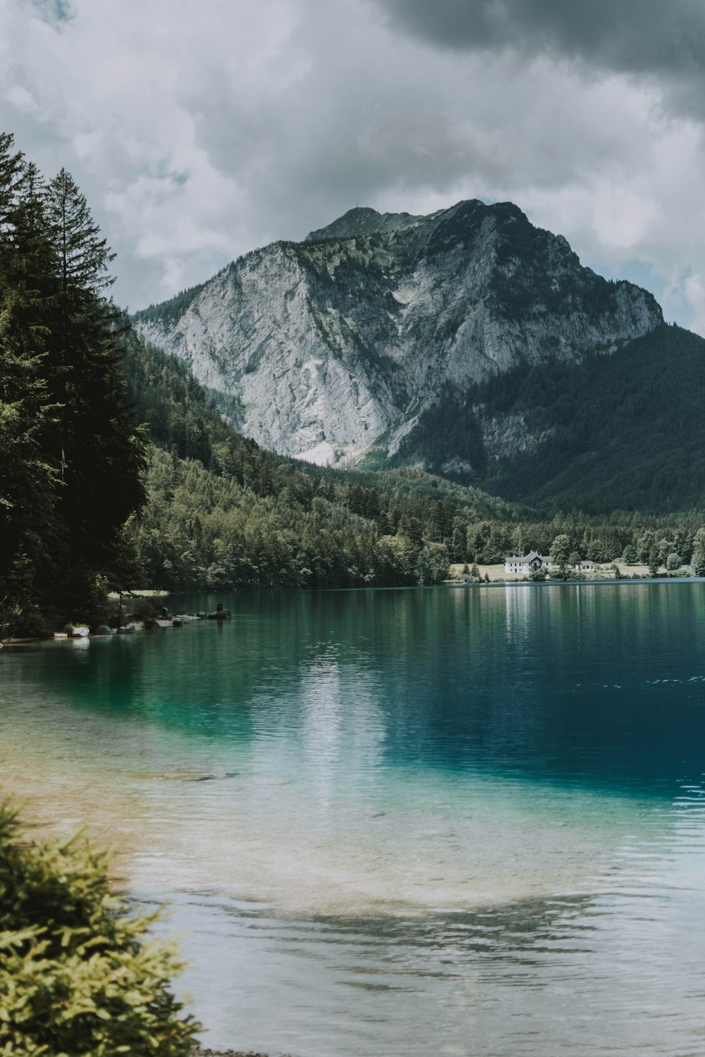 green lake near green trees and mountain during daytime