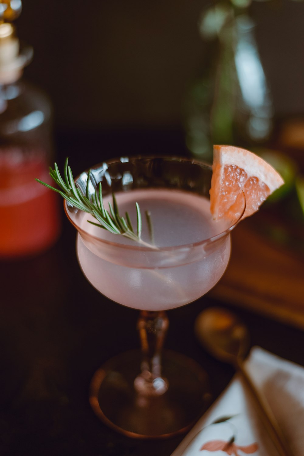 clear cocktail glass with orange liquid