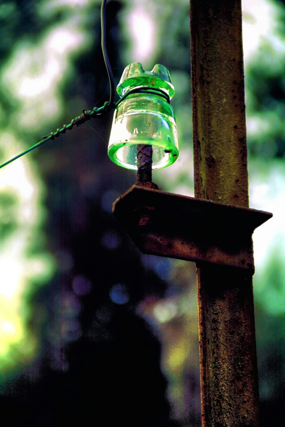 clear glass light bulb hanging on brown wooden post
