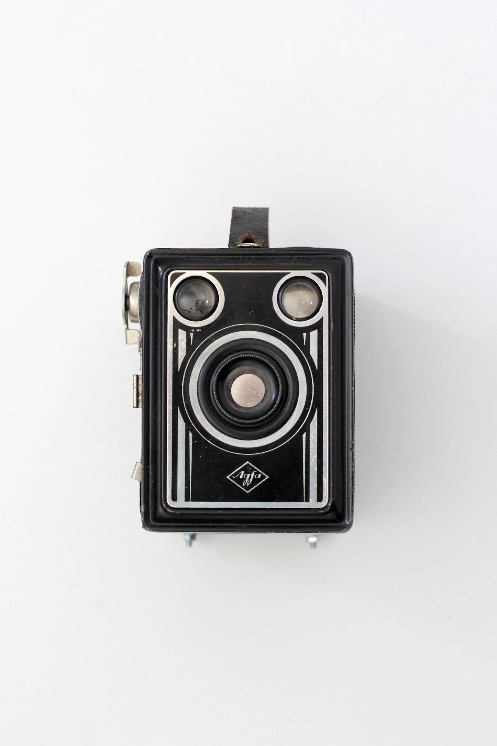 A black and silver compact camera on a white surface