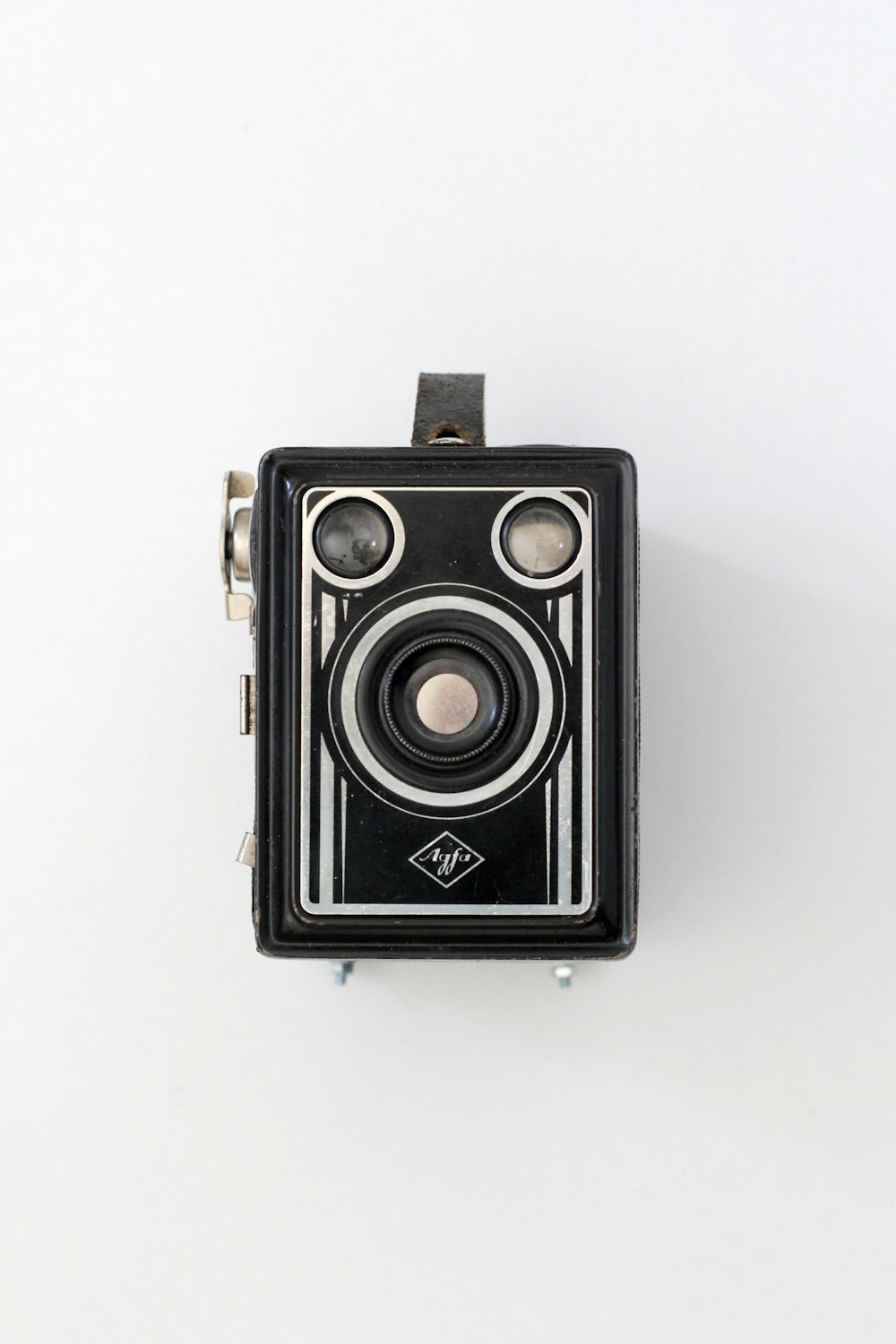 black and silver camera on white surface