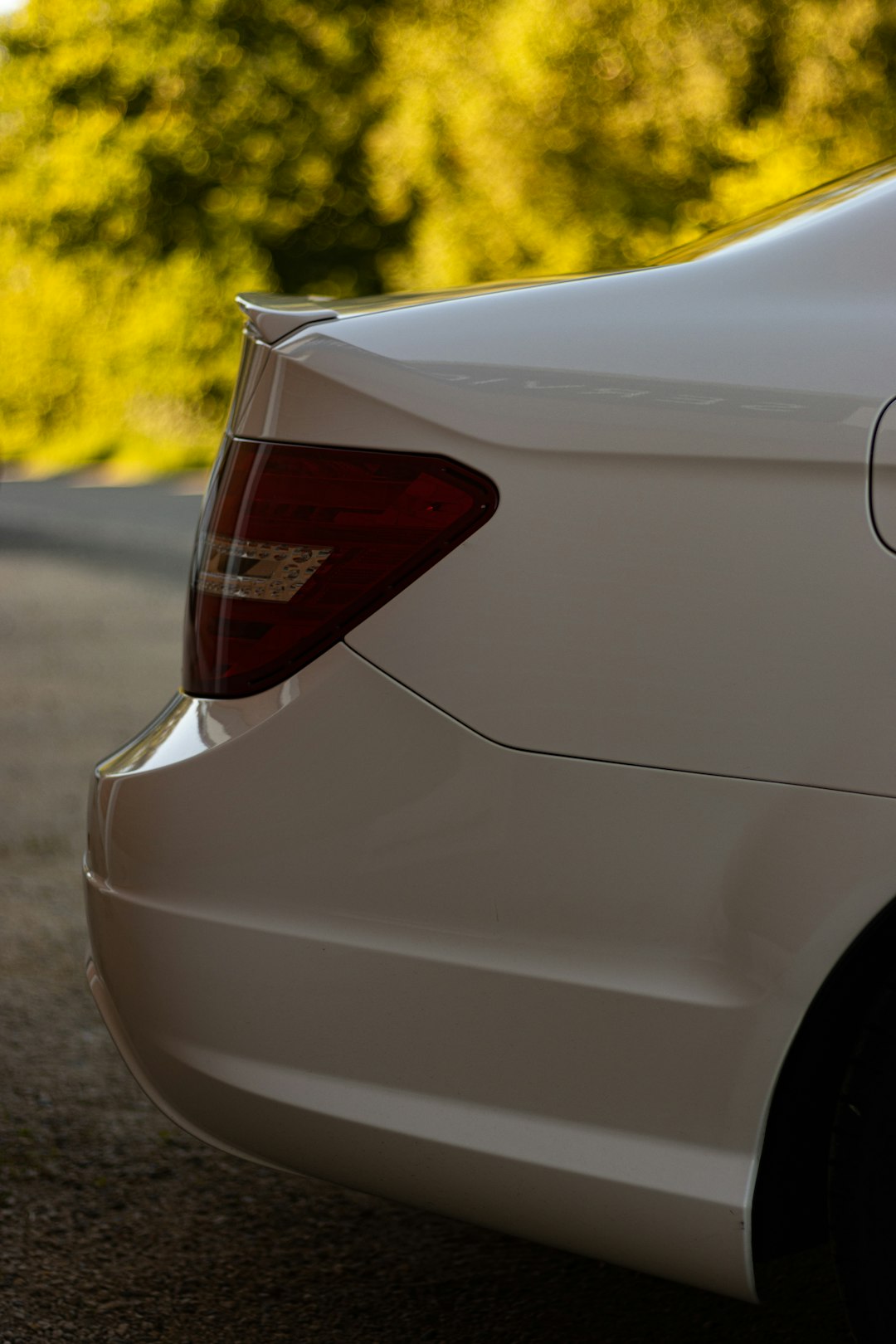 white car on gray asphalt road during daytime