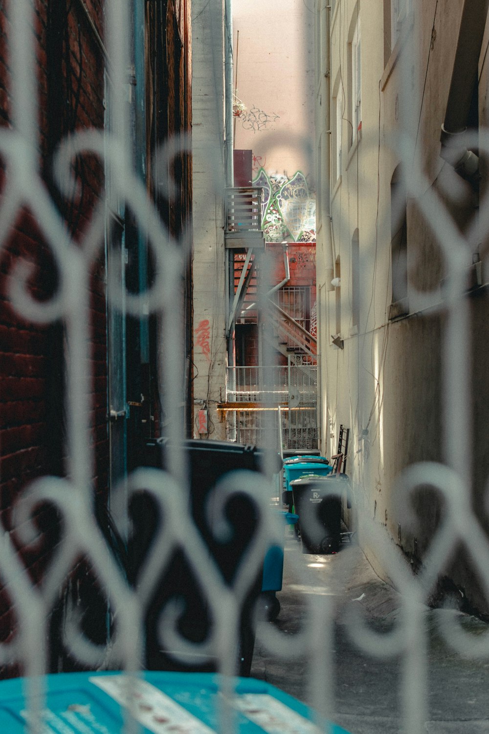 blue car parked beside white concrete building during daytime