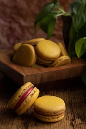 An inviting image of colorful macarons arranged neatly on a rustic wooden tray.