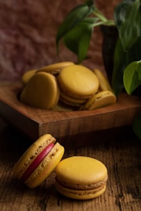 An inviting image of colorful macarons arranged neatly on a rustic wooden tray.