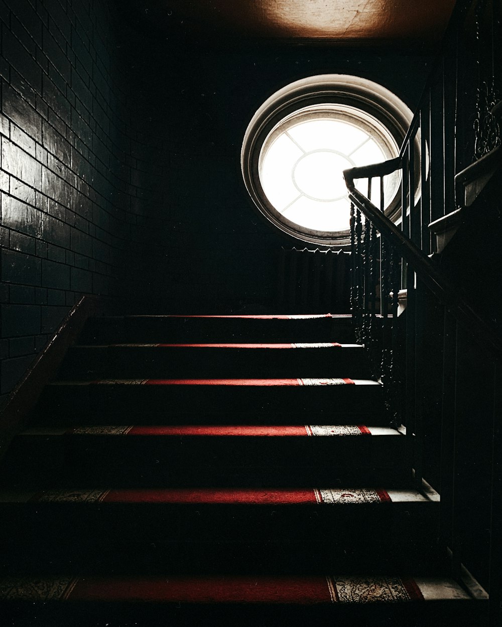 black and red staircase with white round light