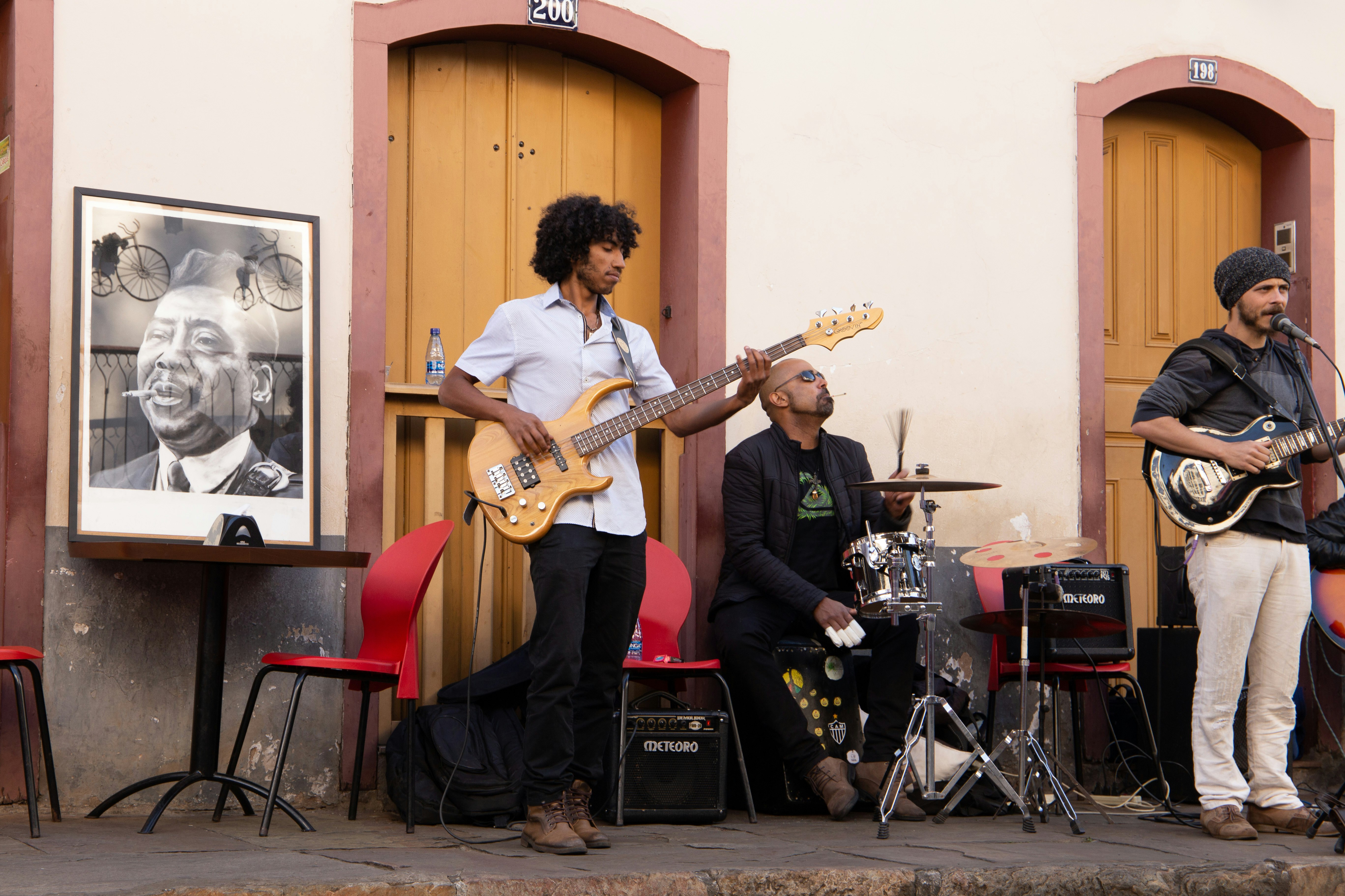 man playing electric guitar sitting on chair