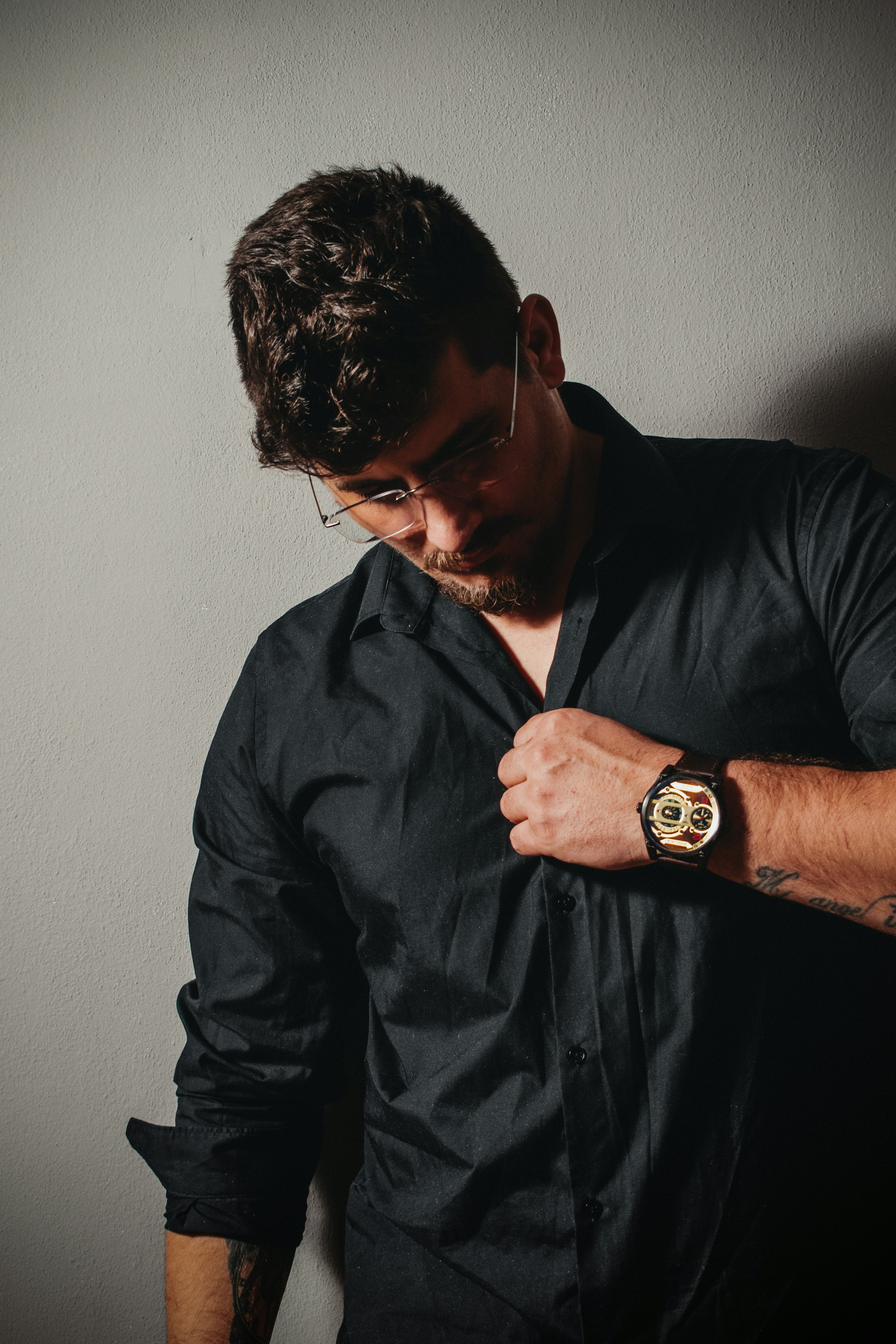 man in black dress shirt wearing black framed eyeglasses